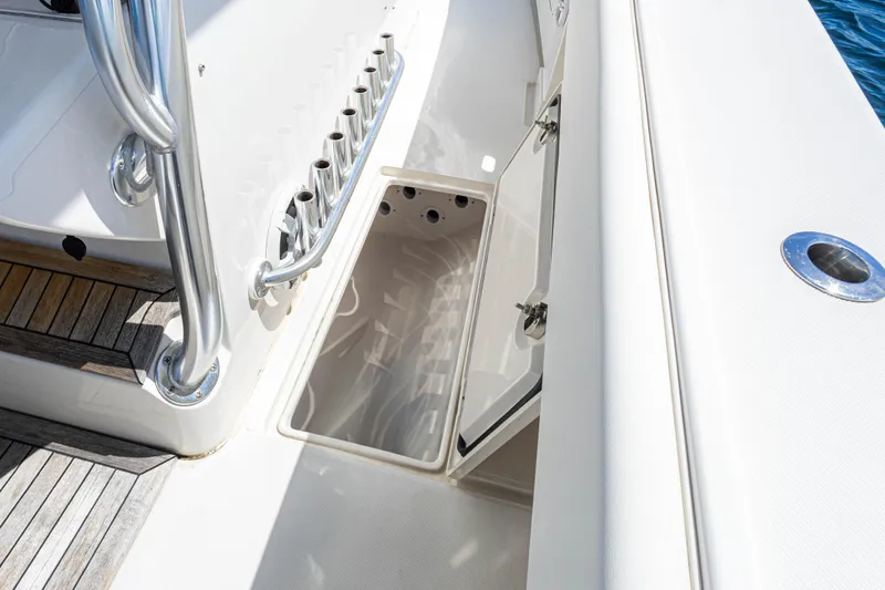Bandit Yacht Photos Pics 2018 Jupiter 38 FS boat deck with open storage compartment and rod holders.
