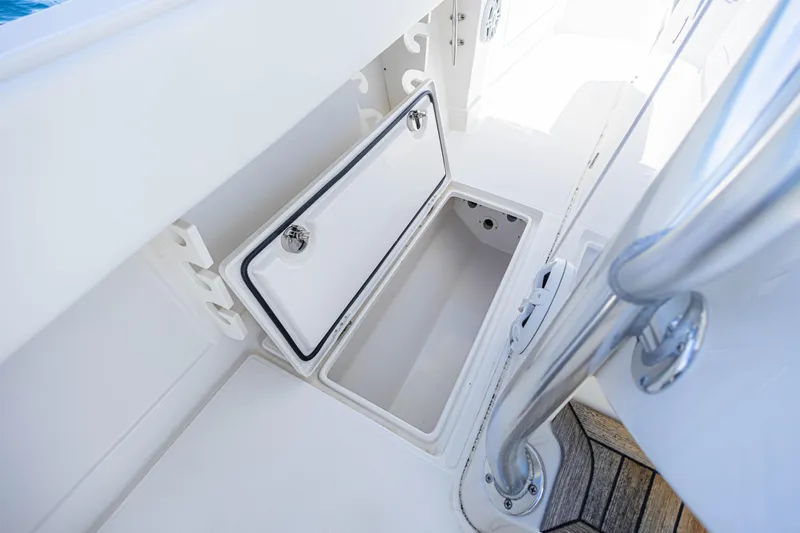 Bandit Yacht Photos Pics Open storage compartment on 2018 Jupiter 38 FS boat deck, featuring sleek white design.