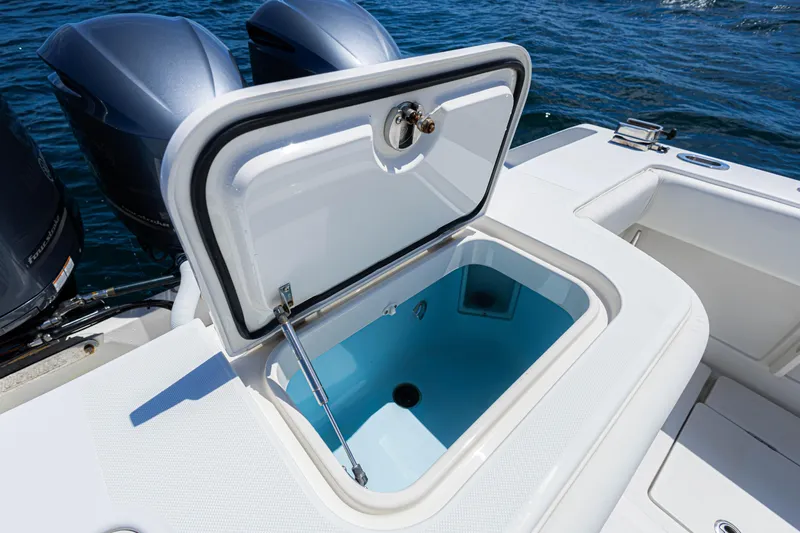 Bandit Yacht Photos Pics 2018 Jupiter 38 FS boat with open storage compartment, twin engines, and ocean backdrop.
