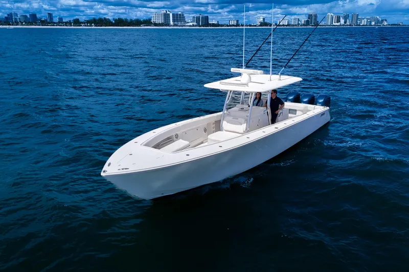 Bandit Yacht Photos Pics 2018 Jupiter 38 FS boat cruising on open water with city skyline in background.