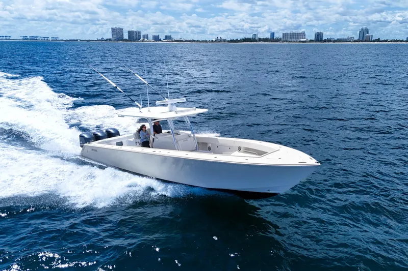 Bandit Yacht Photos Pics 2018 Jupiter 38 FS boat cruising on open water near a city skyline.