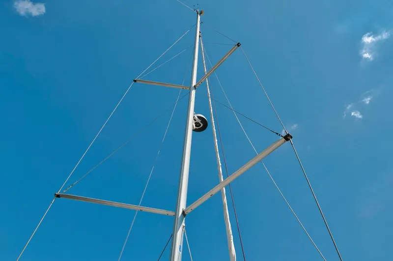 Dantari Yacht Photos Pics Mast of 2021 Jeanneau Sun Odyssey 440 sailboat against clear blue sky.