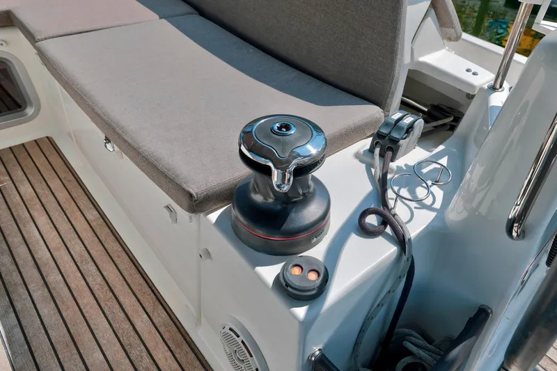 Dantari Yacht Photos Pics Jeanneau Sun Odyssey 440, 2021 model, deck view with winch and seating area.