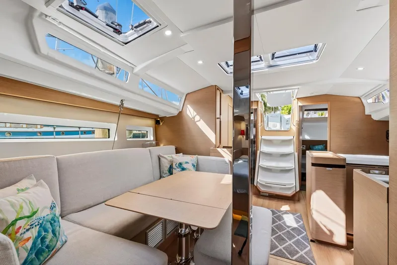 Dantari Yacht Photos Pics Luxurious interior of 2021 Jeanneau Sun Odyssey 440 sailboat with modern design and ample natural light.
