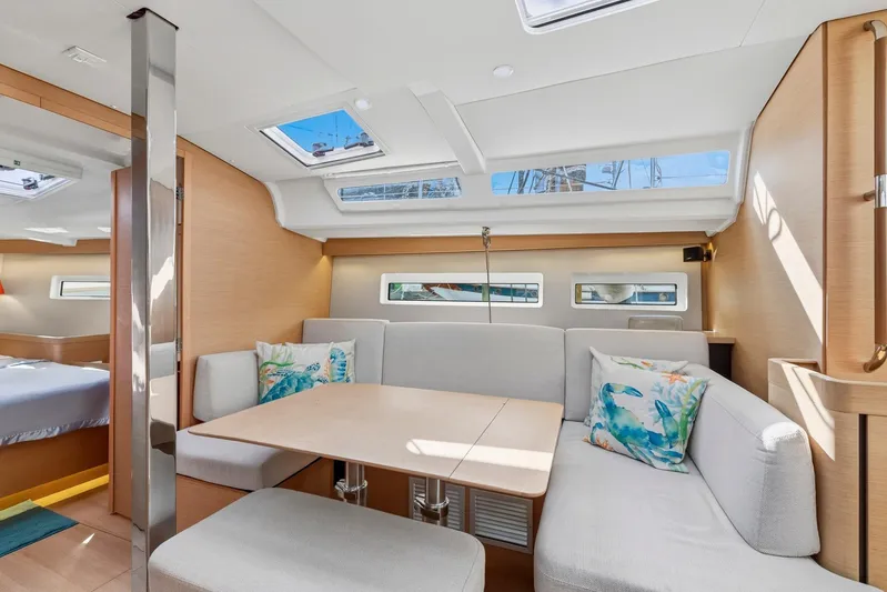 Dantari Yacht Photos Pics Modern interior of 2021 Jeanneau Sun Odyssey 440 yacht with cozy seating and natural light.