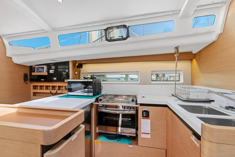 Dantari Yacht Photos Pics Modern kitchen interior of 2021 Jeanneau Sun Odyssey 440 yacht with sleek design and appliances.
