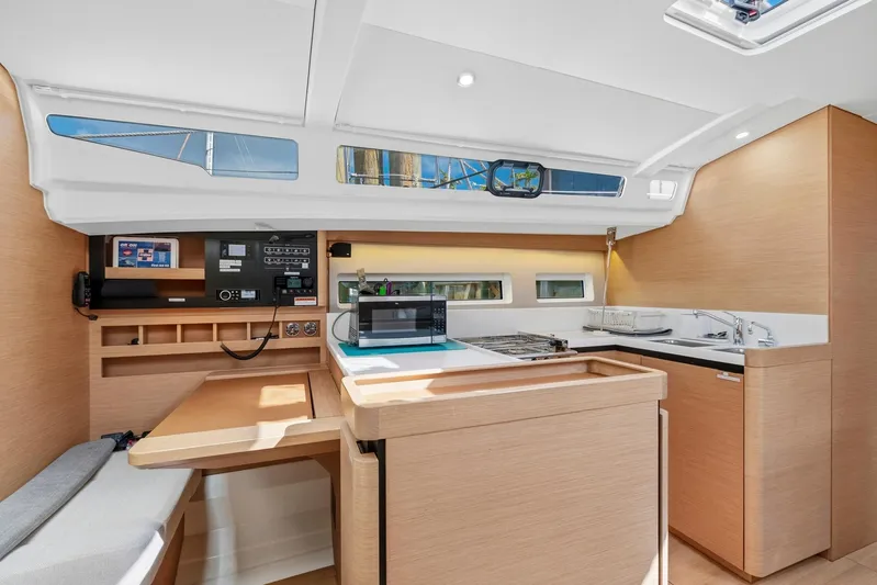 Dantari Yacht Photos Pics Interior of 2021 Jeanneau Sun Odyssey 440 yacht, featuring modern kitchen and navigation area.