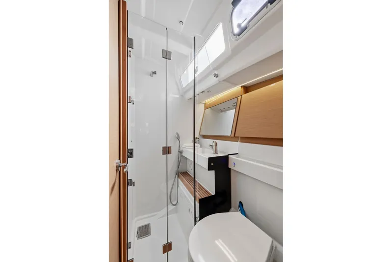 Dantari Yacht Photos Pics Modern bathroom interior of 2021 Jeanneau Sun Odyssey 440 yacht, featuring sleek design and glass shower.