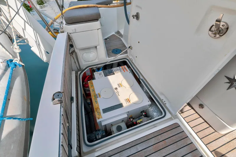 Dantari Yacht Photos Pics Jeanneau Sun Odyssey 440 (2021) engine compartment with open hatch, showcasing equipment and storage.