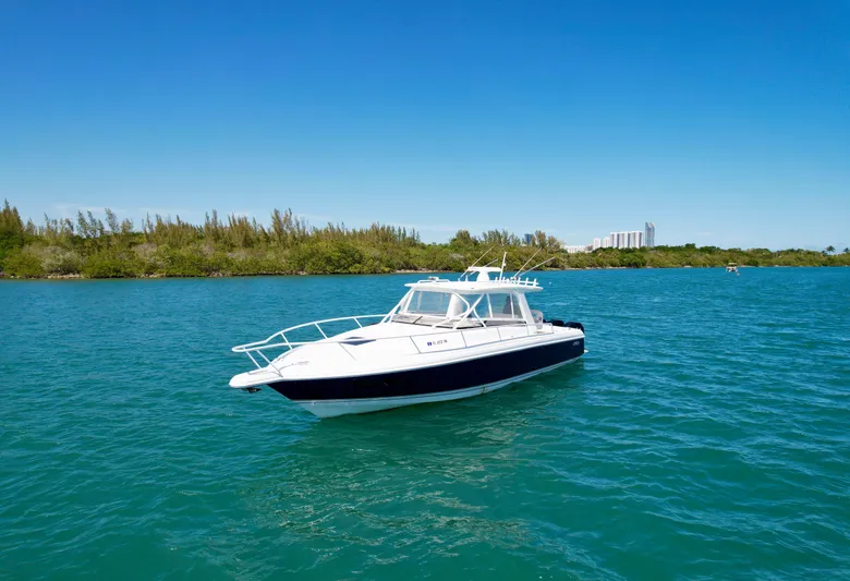  Yacht Photos Pics 2013 Intrepid 390 Sport Yacht on blue water, clear sky background.
