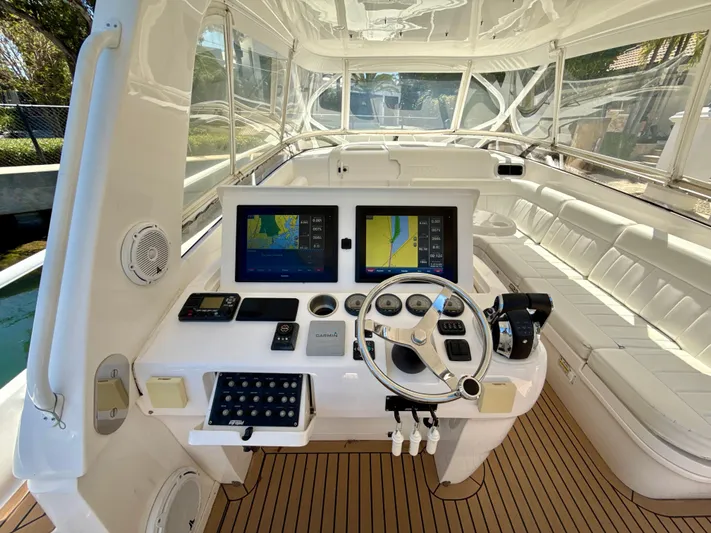  Yacht Photos Pics 2013 Intrepid 390 Sport Yacht cockpit with navigation screens and white seating.