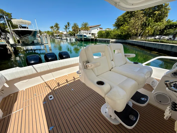  Yacht Photos Pics 2013 Intrepid 390 Sport Yacht with dual white seats, docked by a scenic waterfront.