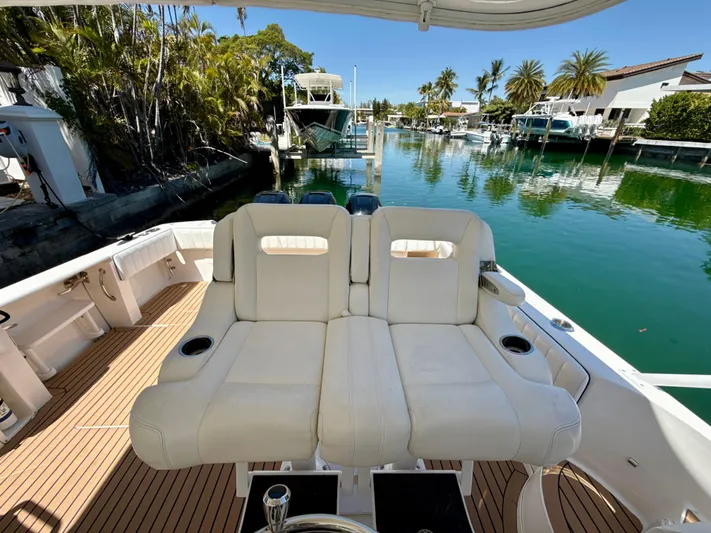  Yacht Photos Pics 2013 Intrepid 390 Sport Yacht with white seating, docked in a scenic marina.