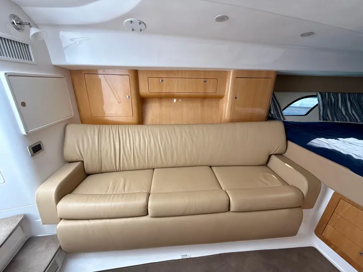  Yacht Photos Pics Interior of 2013 Intrepid 390 Sport Yacht with beige leather sofa and wooden cabinets.