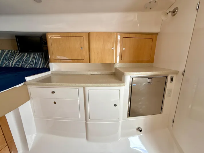  Yacht Photos Pics 2013 Intrepid 390 Sport Yacht interior with cabinets and mini fridge.