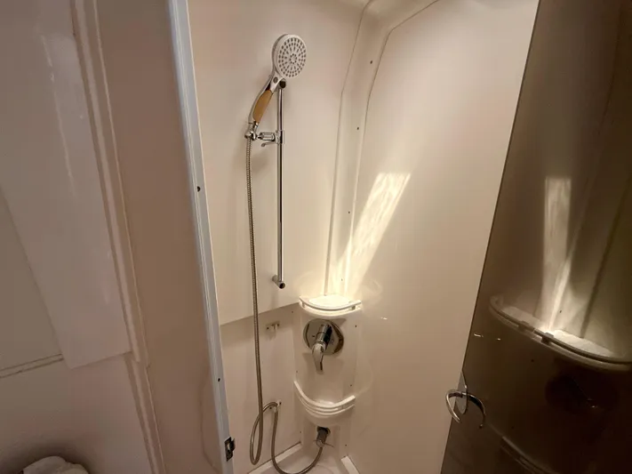  Yacht Photos Pics Shower area in a 2013 Intrepid 390 Sport Yacht, featuring a handheld showerhead.