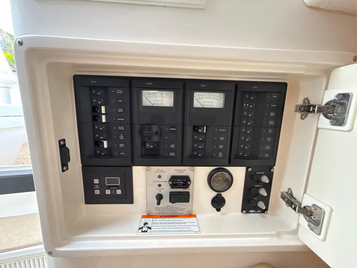 Yacht Photos Pics Electrical control panel of a 2013 Intrepid 390 Sport Yacht, featuring various switches and gauges.