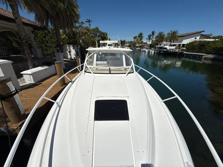  Yacht Photos Pics 2013 Intrepid 390 Sport Yacht docked in a scenic waterfront setting.