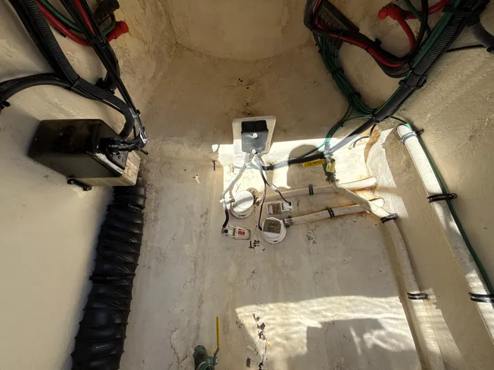  Yacht Photos Pics Bilge area of a 2013 Intrepid 390 Sport Yacht, showing wiring and plumbing components.