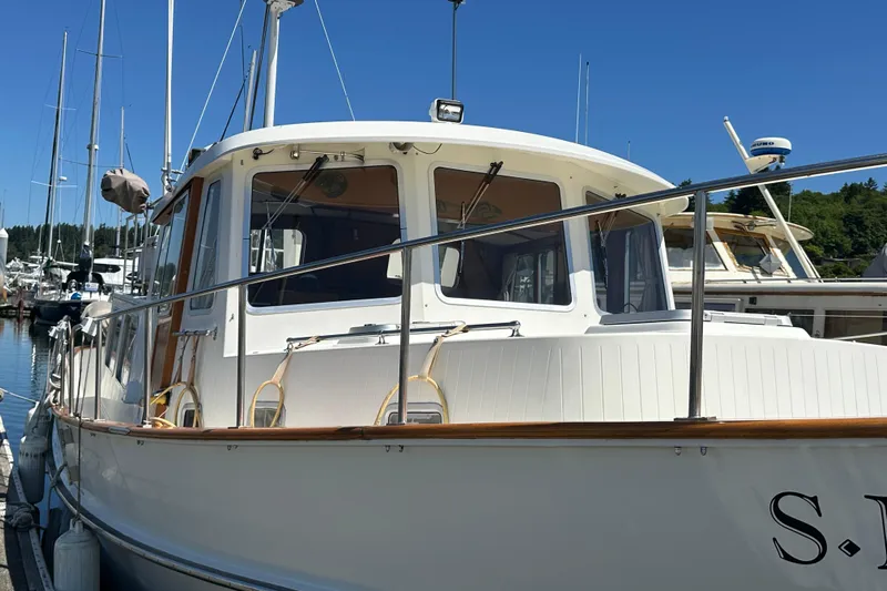 S.k.i Yacht Photos Pics 2000 Eagle 40 Pilothouse Trawler docked at marina under clear blue sky.