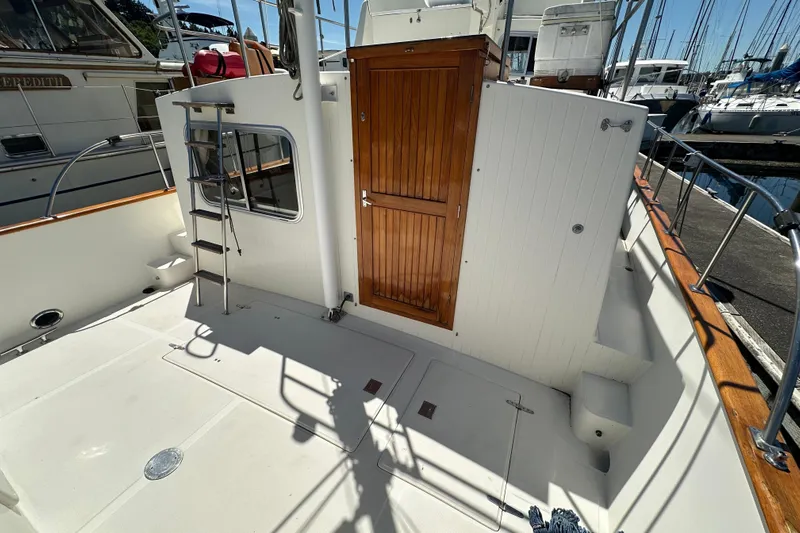 S.k.i Yacht Photos Pics Eagle 40 Pilothouse Trawler 2000, featuring a wooden door and ladder on deck.
