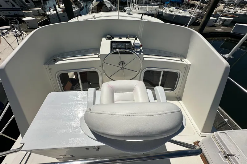 S.k.i Yacht Photos Pics Pilothouse of 2000 Eagle 40 Pilothouse Trawler with steering wheel and captain's chair.