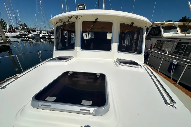 S.k.i Yacht Photos Pics Eagle 40 Pilothouse Trawler 2000 at marina, showcasing deck and pilothouse windows.