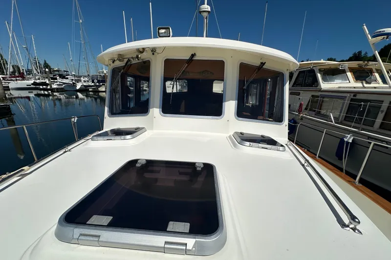 S.k.i Yacht Photos Pics Eagle 40 Pilothouse Trawler 2000 at marina, showcasing deck and pilothouse.