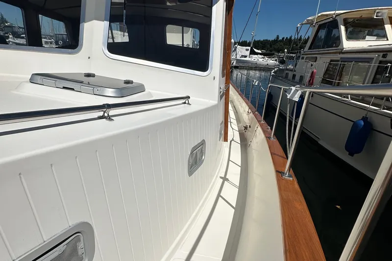 S.k.i Yacht Photos Pics Eagle 40 Pilothouse Trawler 2000, docked, showcasing side deck and railing.