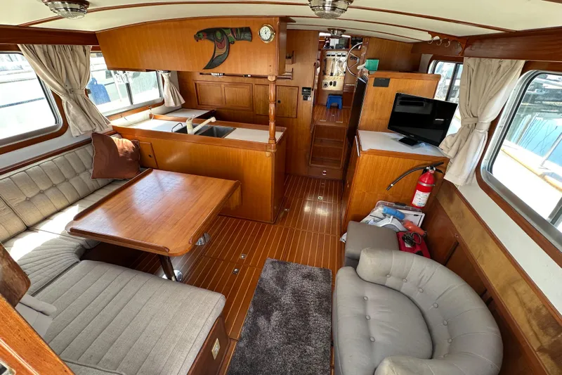 S.k.i Yacht Photos Pics Interior of 2000 Eagle 40 Pilothouse Trawler with wood finish, seating, and TV.