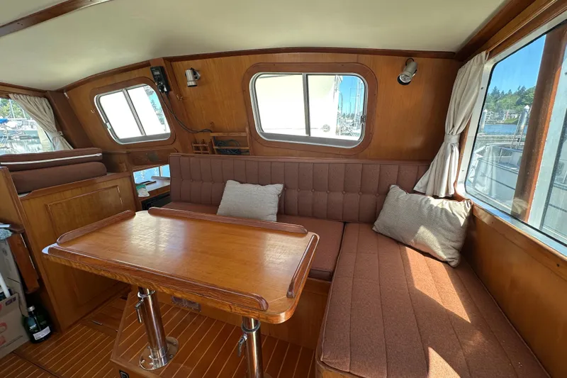 S.k.i Yacht Photos Pics Interior of 2000 Eagle 40 Pilothouse Trawler with wood finish and cozy seating area.