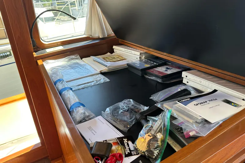 S.k.i Yacht Photos Pics Navigation desk on 2000 Eagle 40 Pilothouse Trawler with maps, manuals, and equipment.