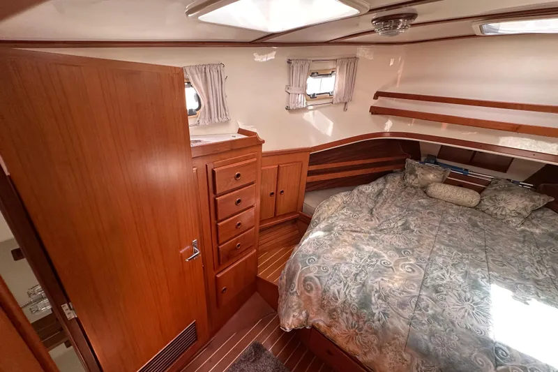 S.k.i Yacht Photos Pics Cozy bedroom in 2000 Eagle 40 Pilothouse Trawler with wood cabinetry and patterned bedding.