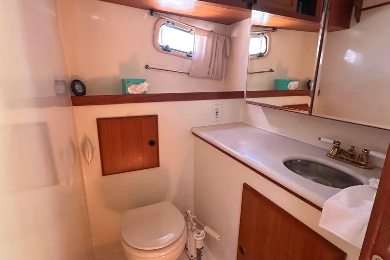 S.k.i Yacht Photos Pics Bathroom interior of 2000 Eagle 40 Pilothouse Trawler with sink, toilet, and mirror.