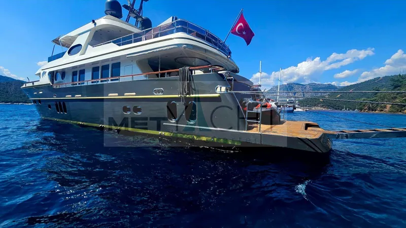  Yacht Photos Pics Luxury Ses Yachts 100, 2010 model, anchored with Turkish flag, scenic coastal backdrop.
