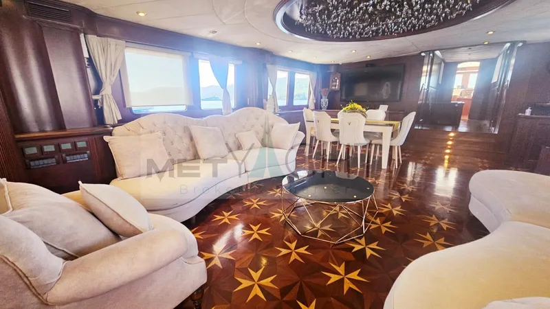  Yacht Photos Pics Luxurious Ses Yachts 100 interior with elegant seating, dining area, and star-patterned wooden flooring.