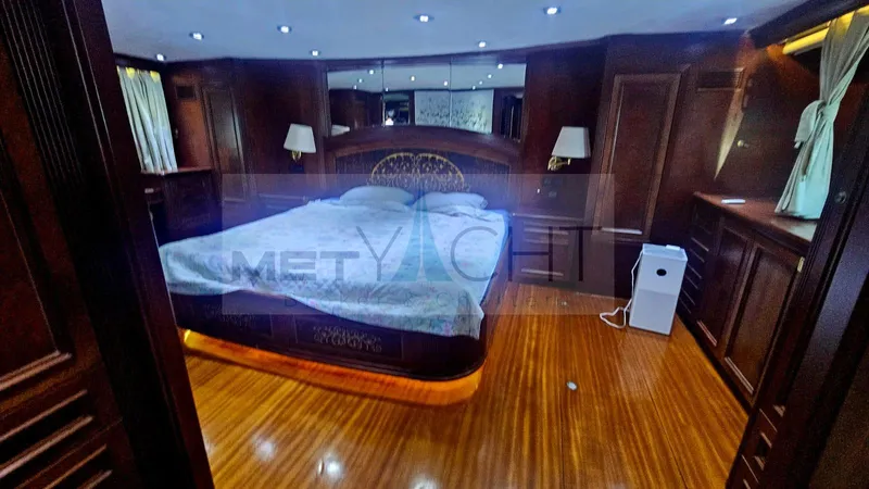  Yacht Photos Pics Luxurious bedroom interior of 2010 Ses Yachts 100, featuring elegant wood finishes and ambient lighting.