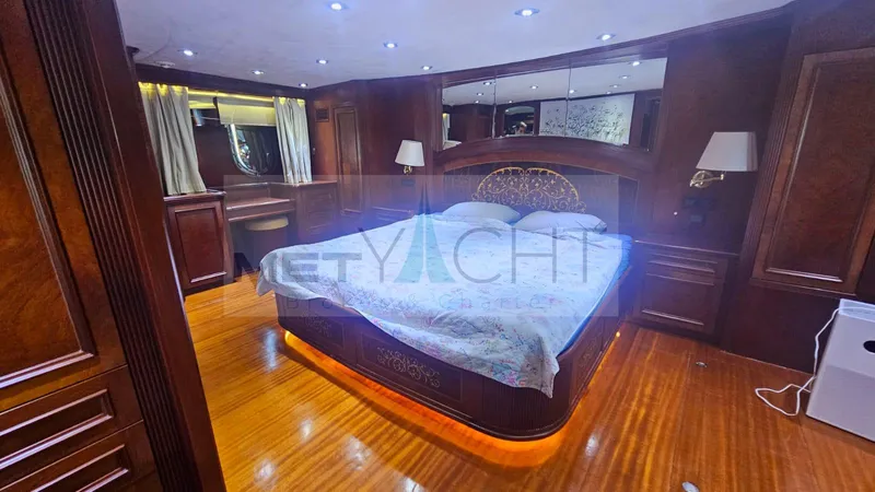  Yacht Photos Pics Luxurious bedroom interior on 2010 Ses Yachts 100, featuring elegant wood finishes and ambient lighting.
