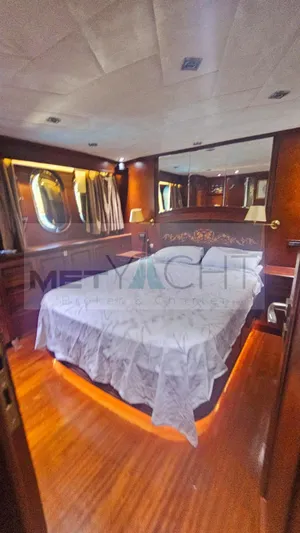  Yacht Photos Pics Luxurious bedroom interior of 2010 Ses Yachts 100, featuring elegant wood finishes and ambient lighting.