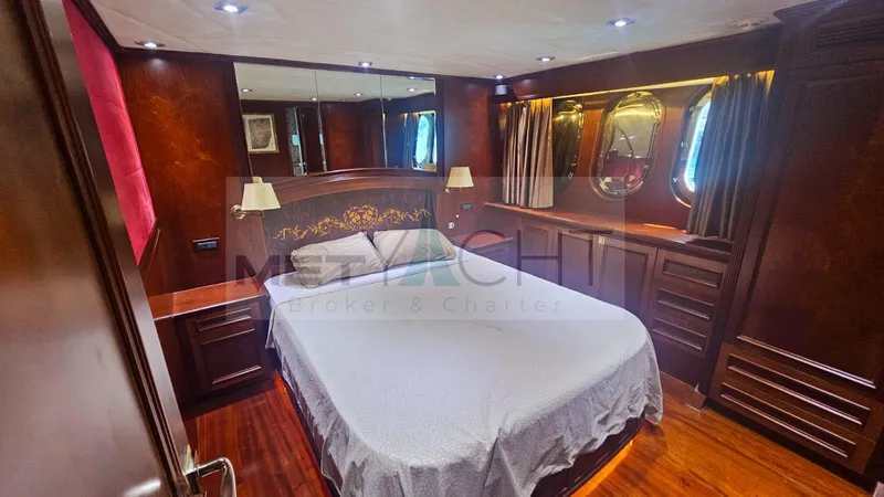  Yacht Photos Pics Luxurious bedroom interior of 2010 Ses Yachts 100 with elegant wood finishes.
