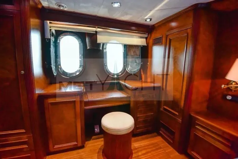  Yacht Photos Pics Luxurious wooden interior of 2010 Ses Yachts 100, featuring elegant porthole windows and seating.