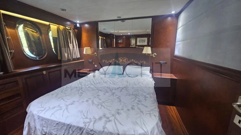 Yacht Photos Pics Luxurious bedroom interior of 2010 Ses Yachts 100, featuring elegant wood paneling and ambient lighting.