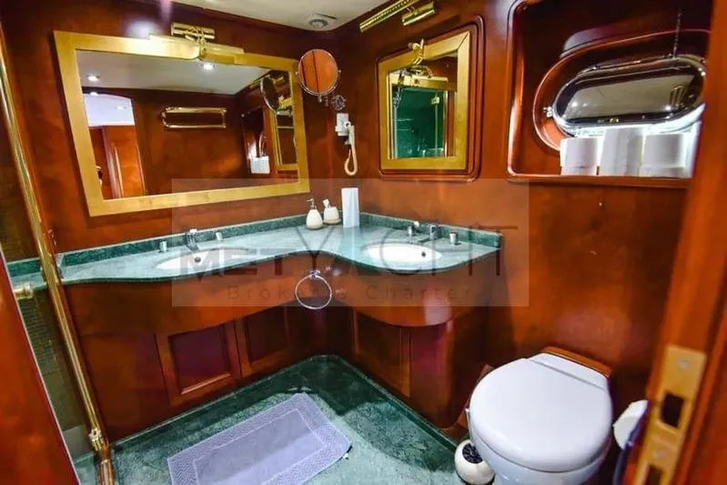  Yacht Photos Pics Luxurious bathroom in 2010 Ses Yachts 100, featuring elegant wood and green accents.