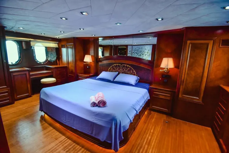  Yacht Photos Pics Luxurious bedroom interior on 2010 Ses Yachts 100, featuring elegant wood finishes and ambient lighting.