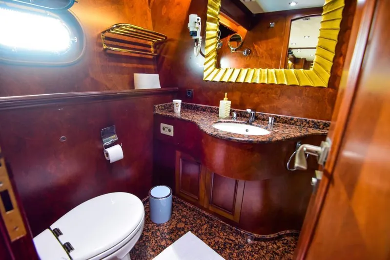  Yacht Photos Pics Luxurious bathroom on 2010 Ses Yachts 100, featuring elegant wood and gold accents.