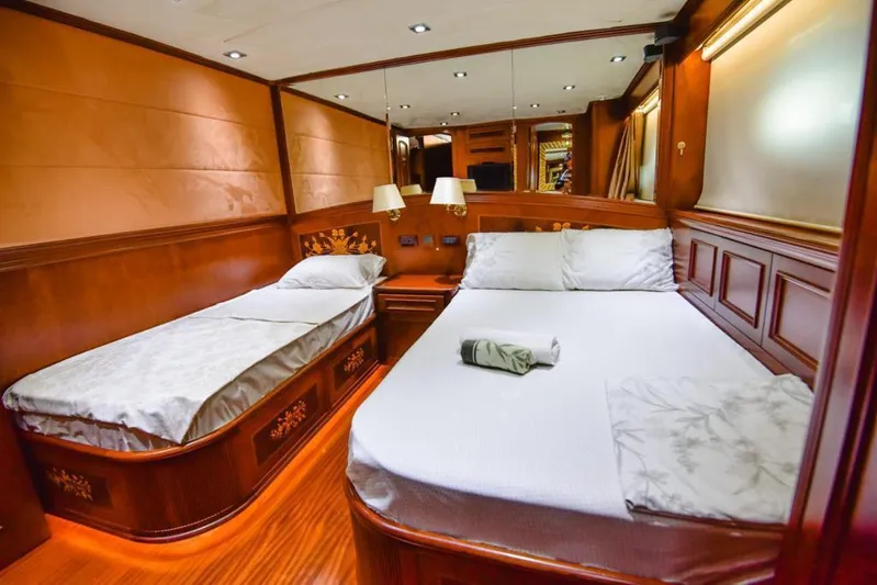  Yacht Photos Pics Luxurious cabin interior of 2010 Ses Yachts 100, featuring elegant wood paneling and cozy beds.