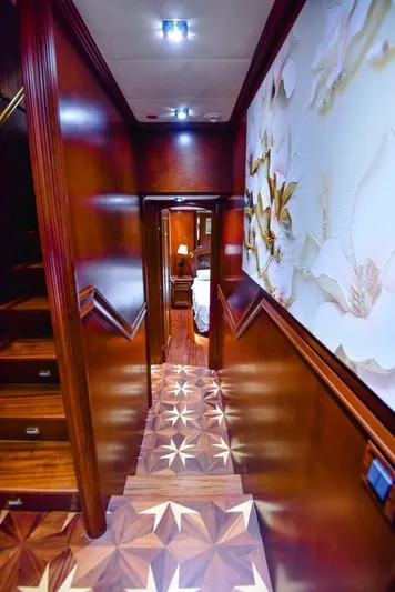  Yacht Photos Pics Luxurious hallway in 2010 Ses Yachts 100, featuring elegant wood paneling and intricate flooring design.