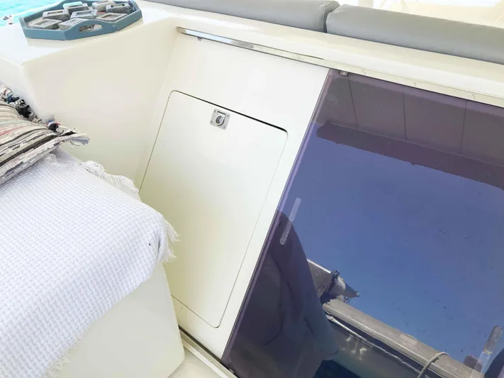 Conan Yacht Photos Pics Cockpit area of 1988 Joubert Custom Trimaran with storage compartment and seating.