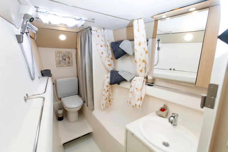 Conan Yacht Photos Pics 1988 Joubert Custom Trimaran bathroom with shower, sink, and toilet.