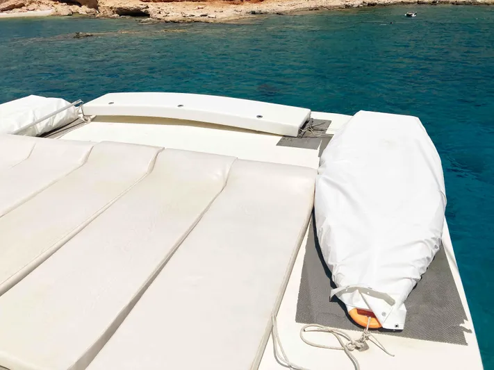 Conan Yacht Photos Pics 1988 Joubert Custom Trimaran deck with white cushions and blue sea background.